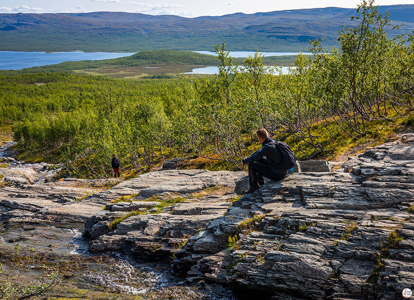 Man admiring Malla Natural Reserve from Kitsi waterfall, Kilpisjärvi, Finland